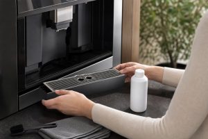 Safe owner-level coffee machine care and inspection scene