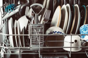 Cutlery basket and plates in a dishwasher rack