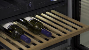 Wine bottles lying on a wine cooler shelf